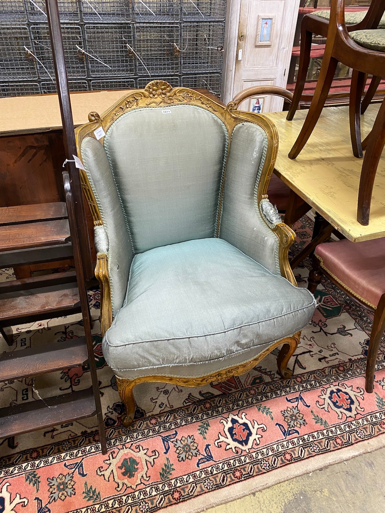 A Louis XV style carved giltwood fauteuil, width 70cm, depth 70cm, height 102cm